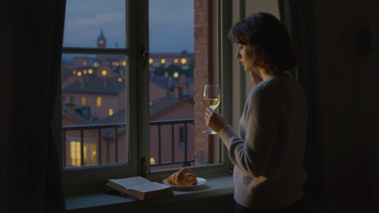 A woman standing alone by a window in Toulouse, holding wine, city lights glowing outside.